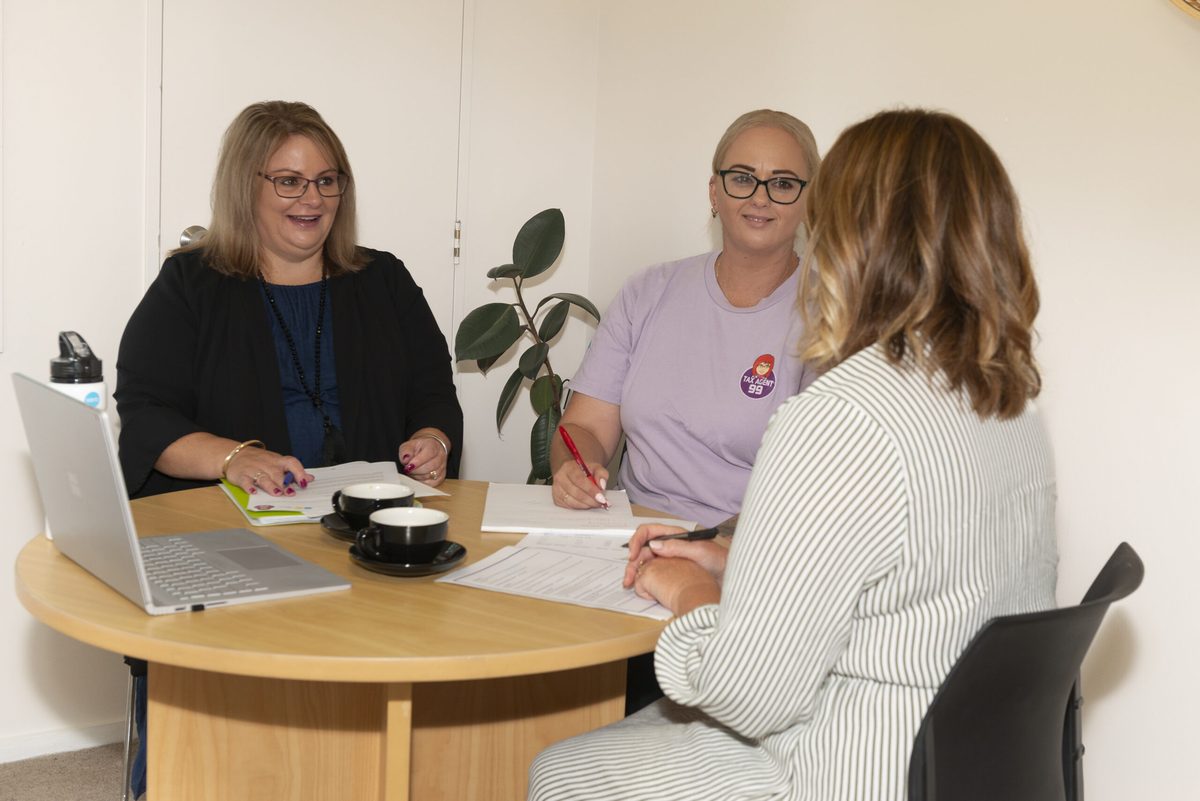 Janine and Vanessa working with a client at the Mount Maunganui office