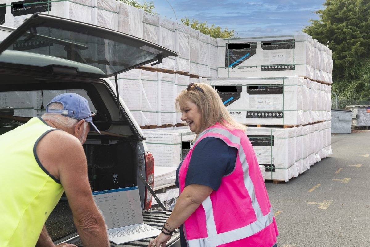 Tradesperson checking their invoices on site